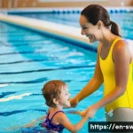 Home 12 수영강사 채용 트렌드 - **Prompt 1: "First Splash of Confidence"**
A heartwarming scene inside a brightly lit indoor com...